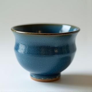 A handcrafted blue ceramic cup.